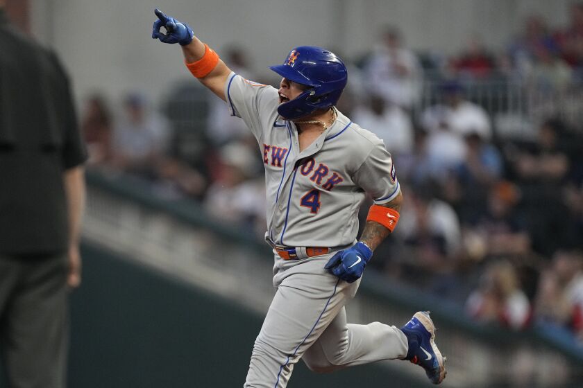 New York Mets' Francisco Alvarez reacts as he rounds the bases after hitting a two-run home run in the fourth inning of a baseball game against the Atlanta Braves, Thursday, June 8, 2023, in Atlanta. (AP Photo/John Bazemore)