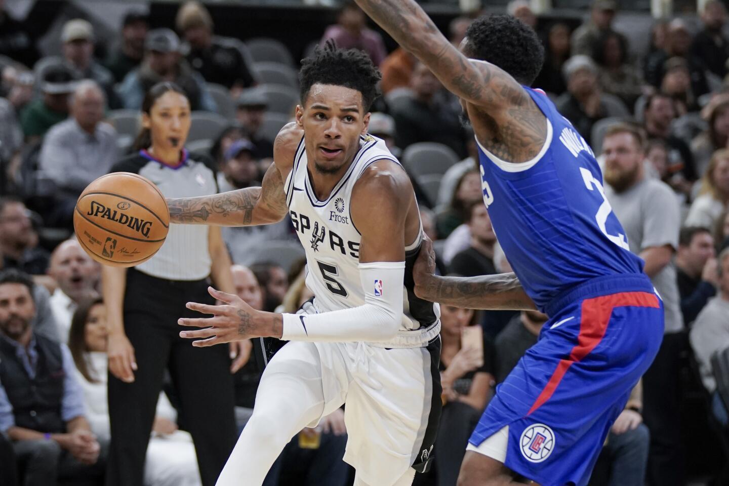 Spurs guard Dejounte Murray drives around Clippers guard Lou Williams during the second half of a game Nov. 29.