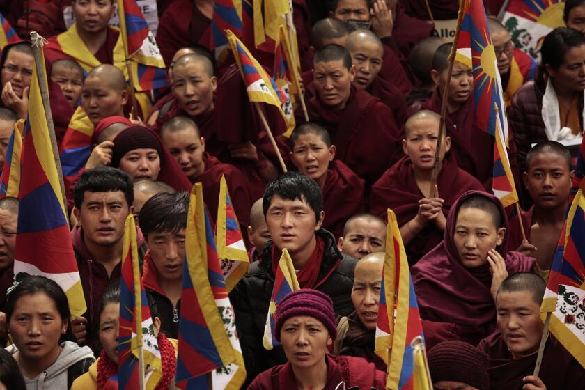 Monks, nuns and other Tibetans take part in a Tibetan Uprising Day protest march, held in Dharamsala, India, on March 10, 2014.