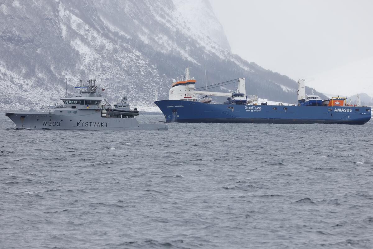 The Dutch cargo ship Eemslift Hendrika is guided to land at Alesund, Norway, Thursday April 8, 2021. Despite heavy seas, a joint Norwegian-Dutch salvage operation has managed to get the abandoned Dutch cargo ship under control off the coast of Norway and towing it to port. Svein Ove Ekornesvåg / NTB