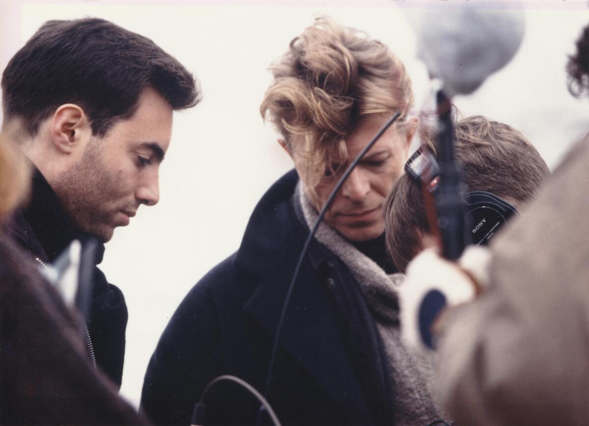 A director speaks with an actor on the set of a movie.