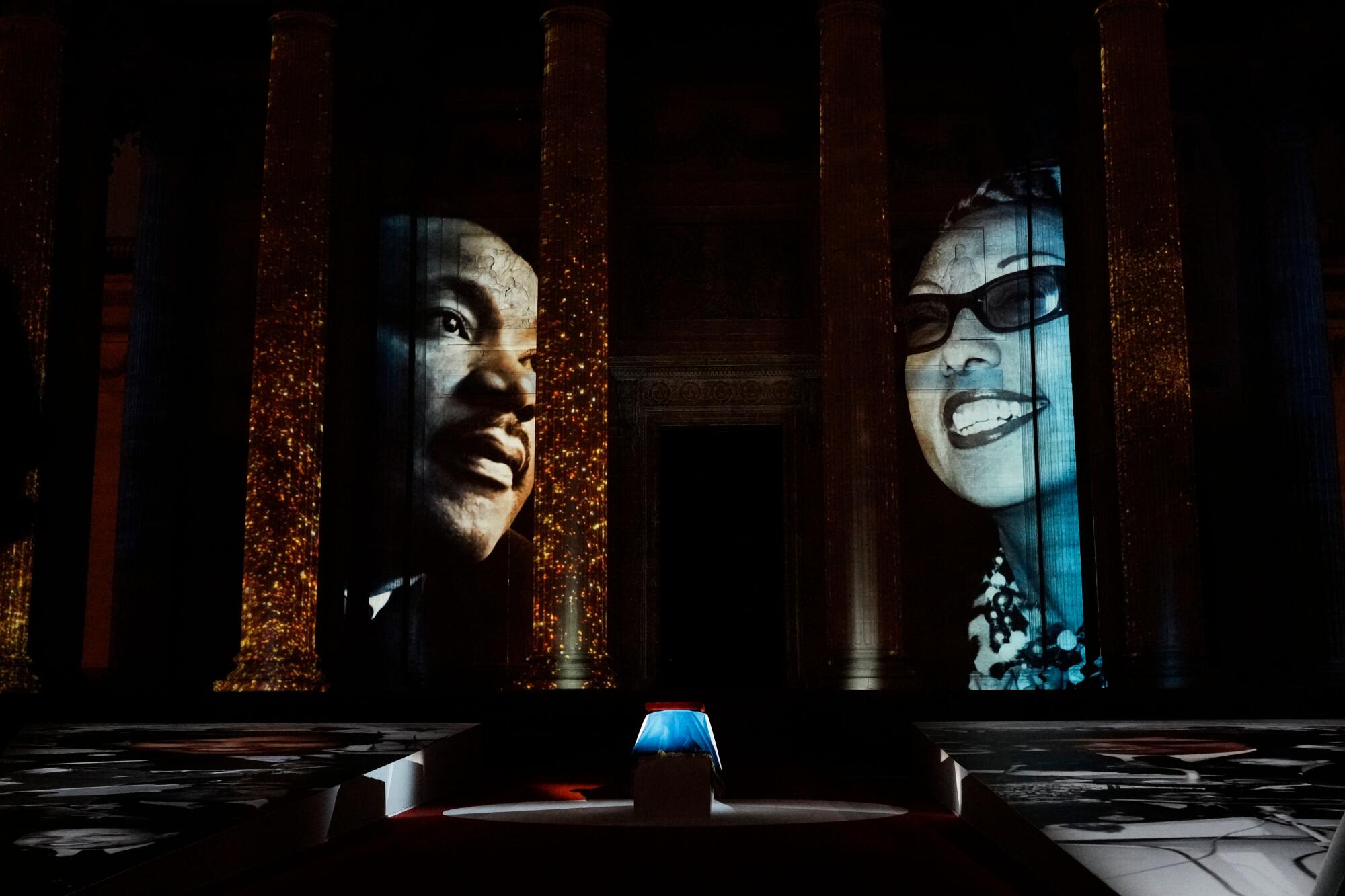 Images of Josephine Baker and the Rev. Martin Luther King Jr. are displayed during the ceremony.