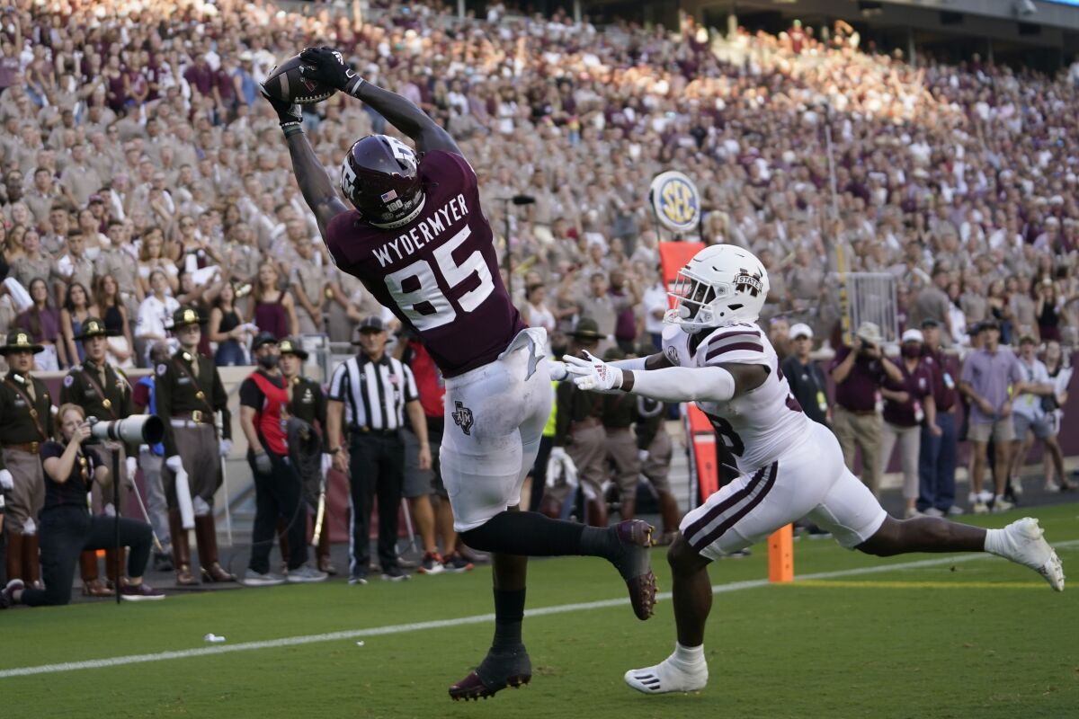 Texas A&M tight end Jalen Wydermyer (85) catches a pass for a touchdown over Mississippi State safety Fred Peters (38) during the first half of an NCAA college football game, Saturday, Oct. 2, 2021, in College Station, Texas. (AP Photo/Sam Craft)