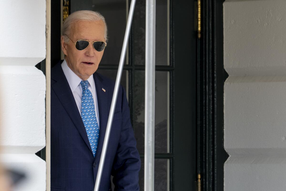 President Biden in sunglasses, pictured from the waist up