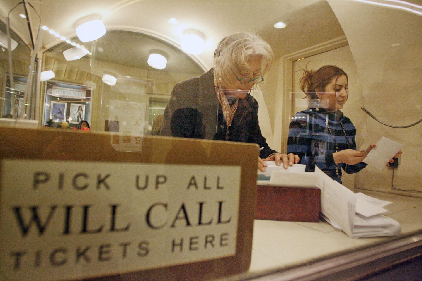 Mary Kathryn Walsh, left, and Mariam Panasyan distribute tickets to customers for the "Territory of Jazz" performance at the Alex Theatre in Glendale on Friday, December 28, 2012.