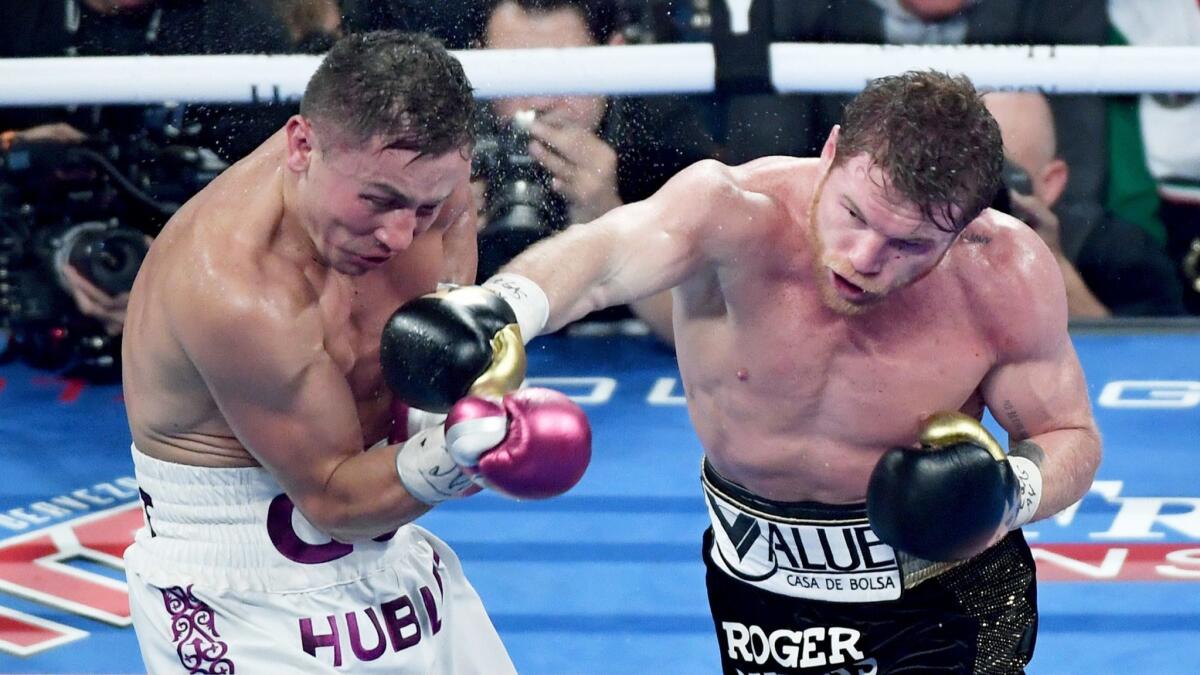 Canelo Alvarez, right, throws a punch at Gennady Golovkin during the fifth round of their title fight in September.