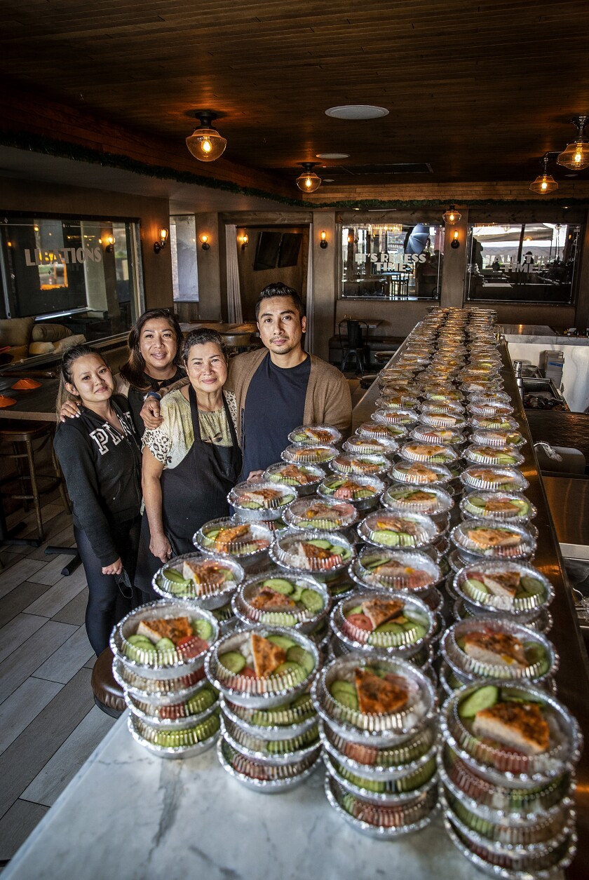 Nhi Huynh, Huong Pham, Kim Huynh and Viet Pham, stand with about 600 Han Vi meals