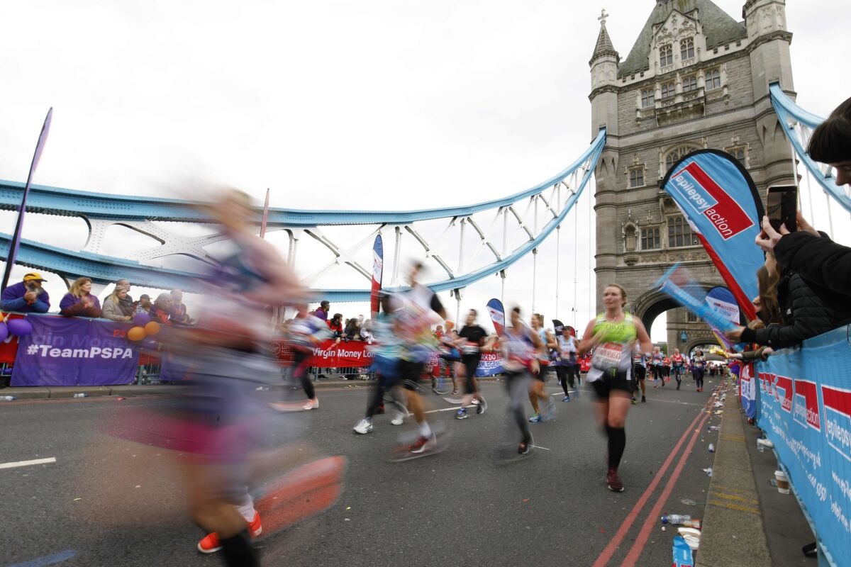 Competitors run across Tower Bridge during the 2019 London Marathon on April 28.