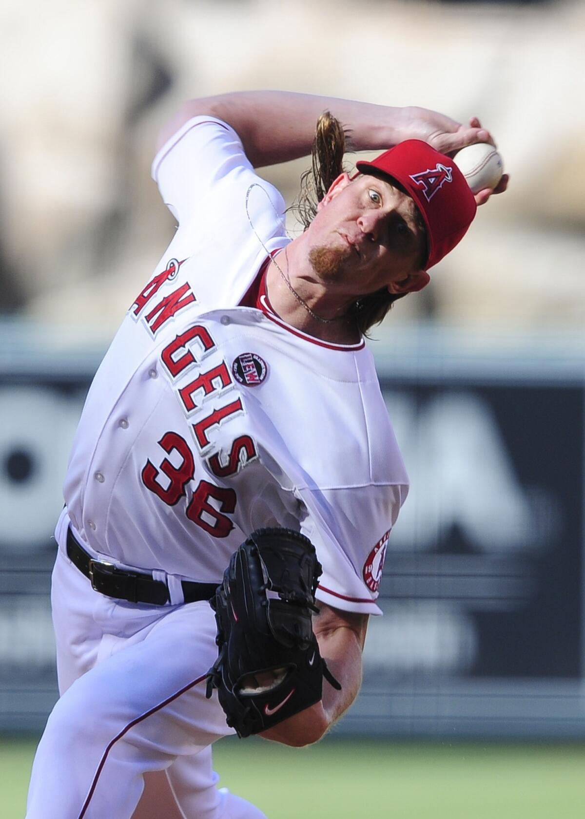 Angels starter Jered Weaver delivers a pitch during the first inning of the Angels' 3-0 victory over the Boston Red Sox on Sunday.