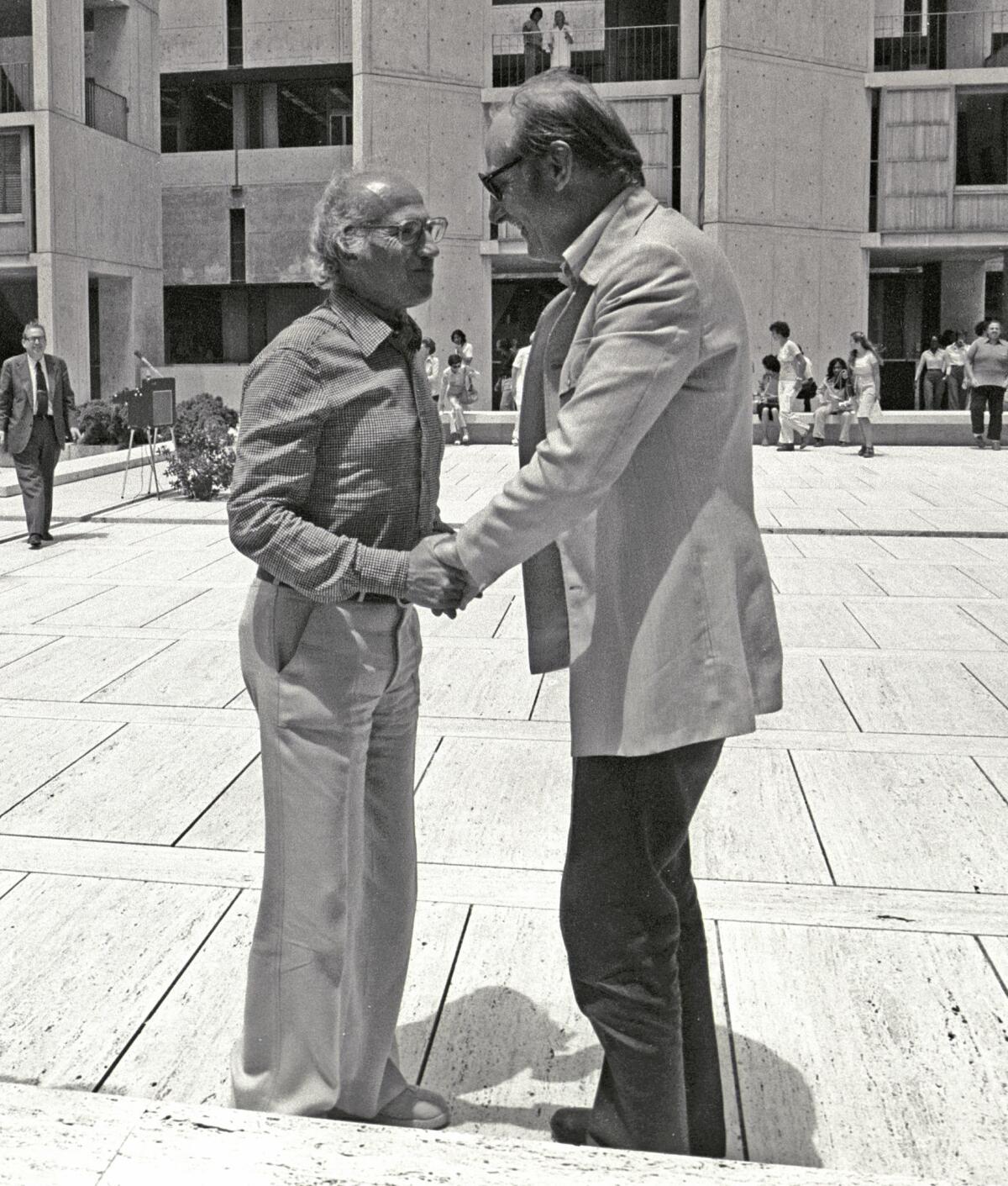 Jonas Salk (left) and Francis Crick talk in the courtyard of the Salk Institute for Biological Studies in La Jolla. Crick became a non-resident fellow of the Salk even before the institute was built.
