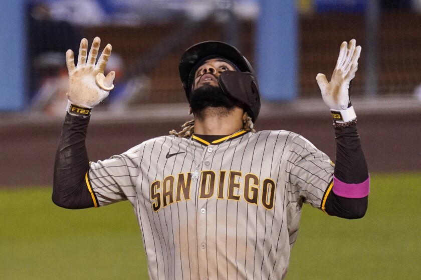 San Diego Padres' Fernando Tatis Jr. celebrates his solo home run as he scores during the fifth inning of a baseball game against the Los Angeles Dodgers Friday, April 23, 2021, in Los Angeles. (AP Photo/Mark J. Terrill)