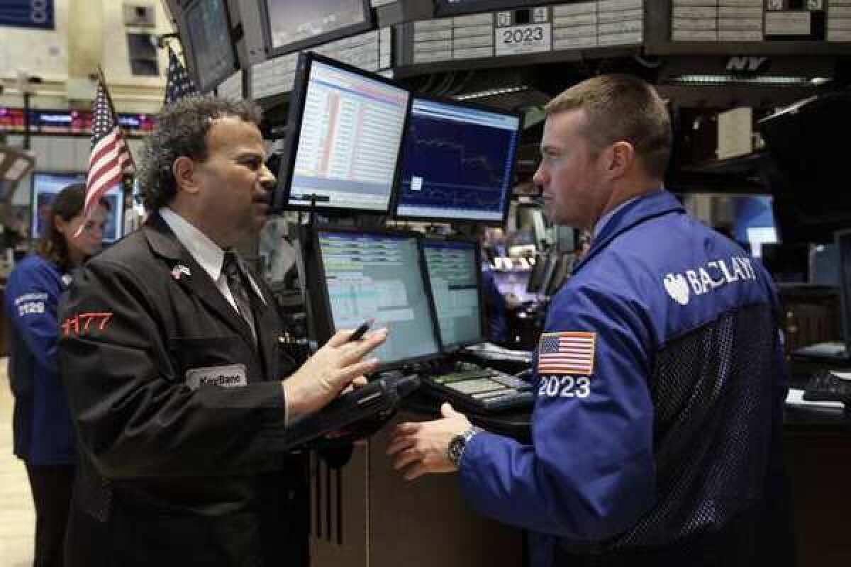 Traders work on the floor of the New York Stock Exchange. Stocks remain reasonable priced despite this year's rally.