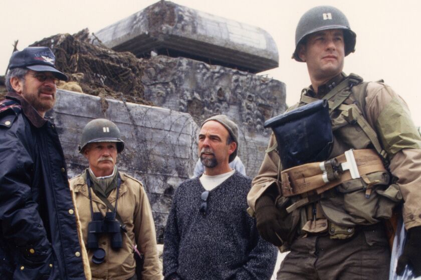 Preparing for action on their version of Omaha Beach: (l to r) director Steven Spielberg, senior military advisor Dale Dye, production designer Tom Sanders, and Tom Hanks on the set of "Saving Private Ryan." CREDIT: David James /DreamWorks LLC/Paramount Pictures/Amblin Entertainment