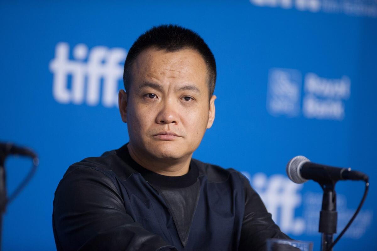 Director Ning Hao listens to a question during a Sept. 7 news conference for "Breakup Buddies" at the Toronto International Film Festival.