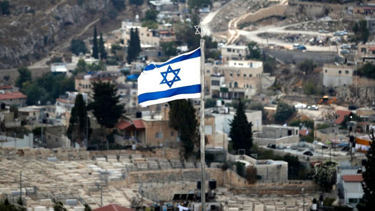 The Israeli flag flutters over the Mount of Olives adjacent to Jerusalem's Old City.