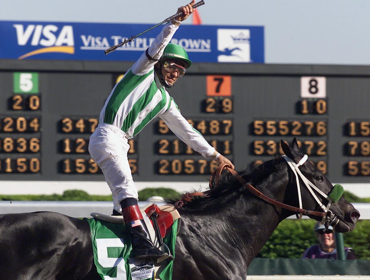 Jockey Victor Espinoza celebrates after riding War Emblem to victory in the 128th Kentucky Derby at Churchill Downs on Saturday, May 4, 2002, in Louisville, Ky.