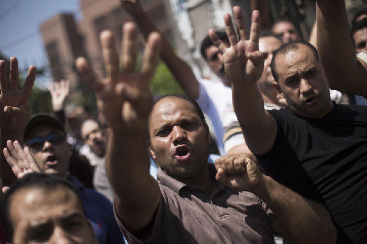 Supporters of Egypt's ousted President Mohamed Morsi chant slogans against the Egyptian army during a march Friday near Al Nour mosque in Cairo's Abassia district.