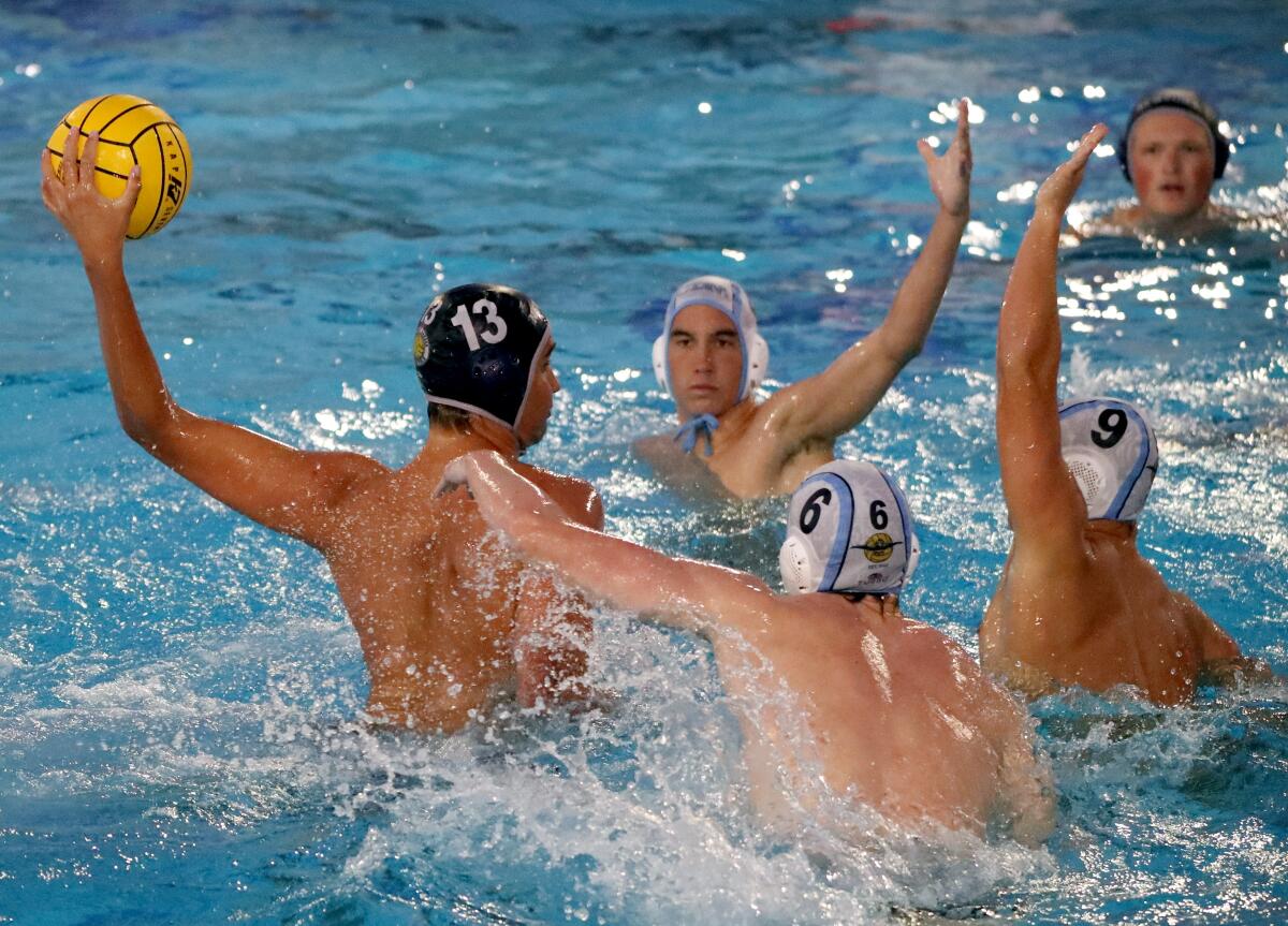 Newport Harbor High School's Ben Liechty (13) takes a shot on goal in a home game vs. Corona del Mar High.