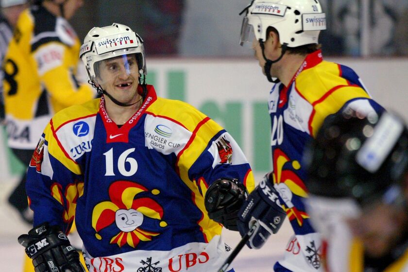 Finnish team Jokerit Helsinki's Ville Peltonen, left, reacts with his teammate Petri Palaslahti, after he scored the last goal for his team against Germany's team Krefeld Pinguins, during their game, at the second day of the 77th Spengler Cup icehockey tournament in Davos, Switzerland, Saturday, Dec. 27, 2003. (AP Photo/Keystone/Fabrice Coffrini)
