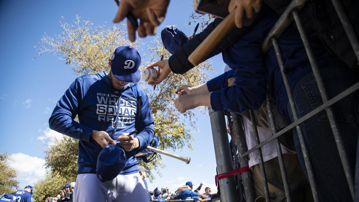 It's that time again. Dodgers outfielder Cody Bellinger signs autographs during spring training at Camelback Ranch Glendale, Ariz.