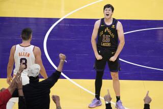 Los Angeles Lakers guard Austin Reaves, right, celebrates along with fans after hitting a three-point shot late in the game as Phoenix Suns guard Grayson Allen watches during the second half of an NBA basketball In-Season Tournament quarterfinal game Tuesday, Dec. 5, 2023, in Los Angeles. (AP Photo/Mark J. Terrill)