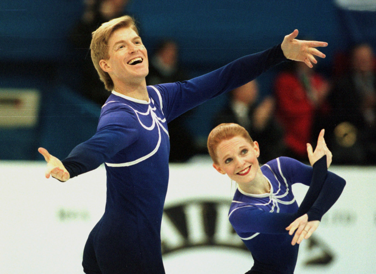Jenni Meno and Todd Sand acknowledge the crowd during their pairs short program.