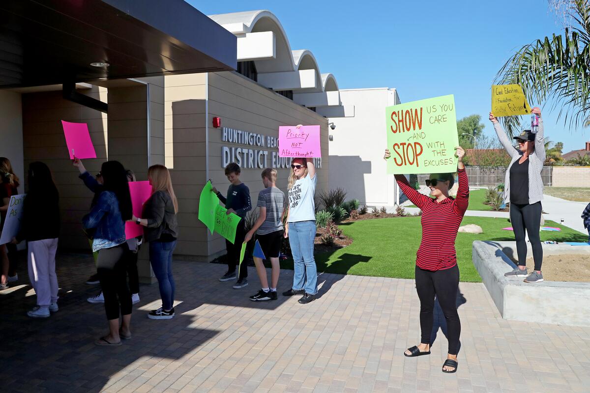 Parents and students protest in front of the Huntington Beach City School District office on Wednesday morning.