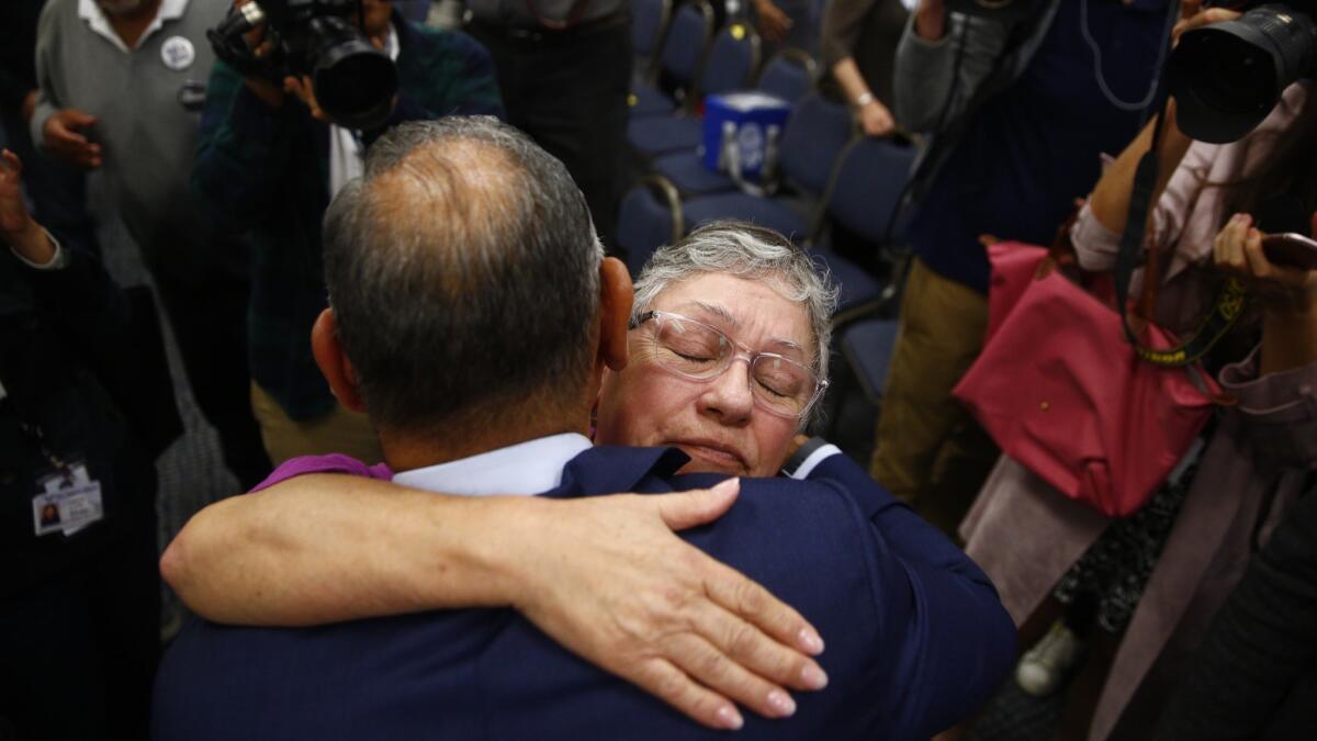 Gil Cisneros hugs his mother, Elizabeth Cisneros, at the victory rally. The Navy veteran will succeed retiring 12-term Republican Rep. Ed Royce in the district that straddles Orange, San Bernardino and Los Angeles counties.