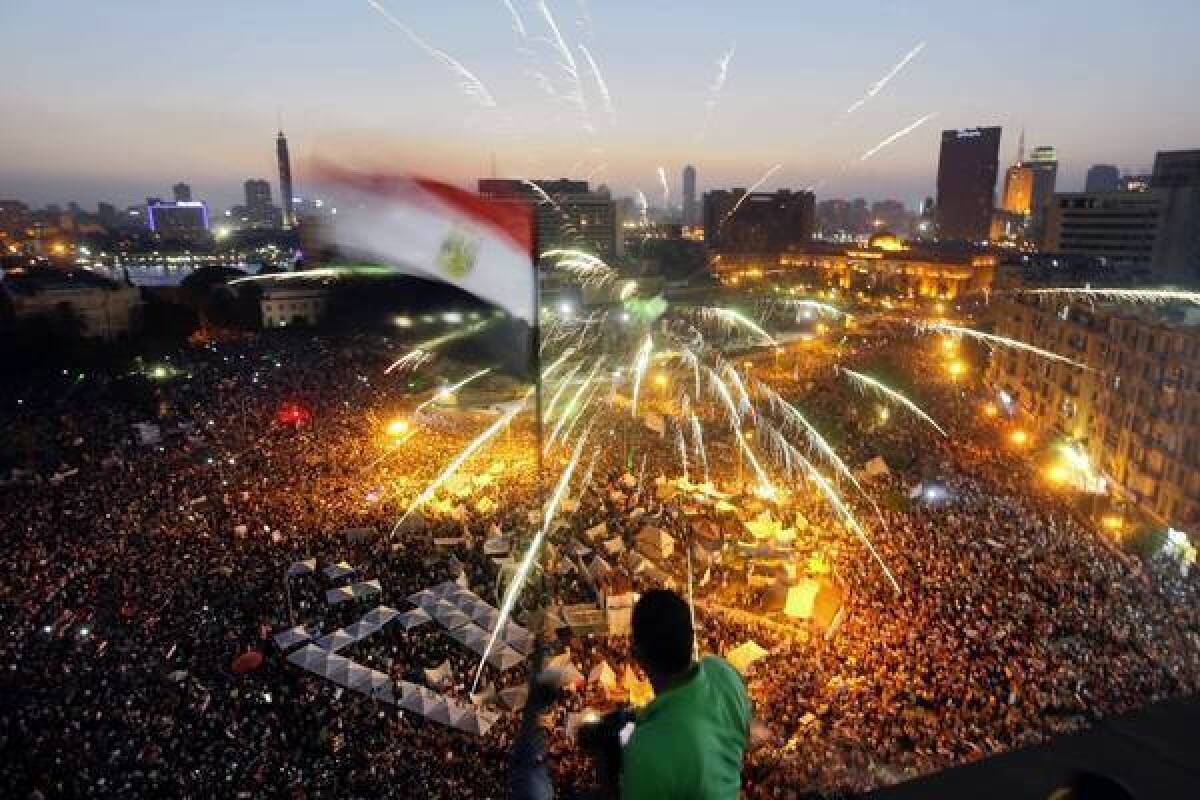 A protester waves a national flag as Egyptians gather in Tahrir Square during a demonstration against President Mohamed Morsi in Cairo.