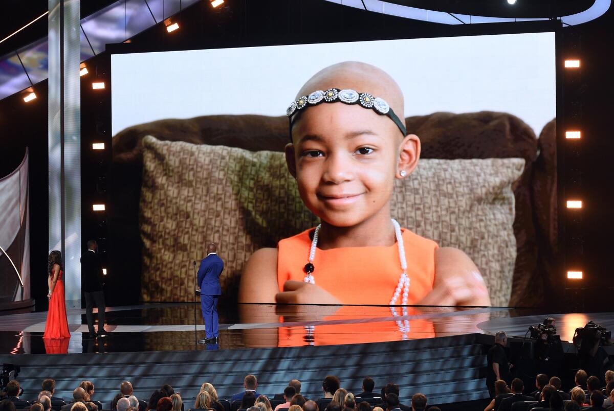 A video of Leah Still plays as Devon Still accepts the Jimmy V Award for Perseverance during the ESPYS at Microsoft Theater on Wednesday.
