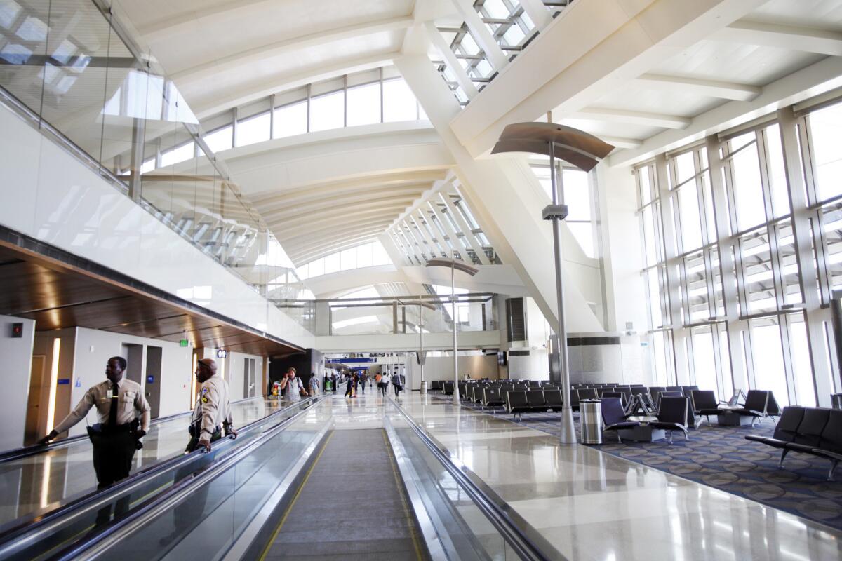 Passengers walk through the remodeled and expanded Tom Bradley International Terminal at LAX, which is undergoing a multibillion-dollar modernization.