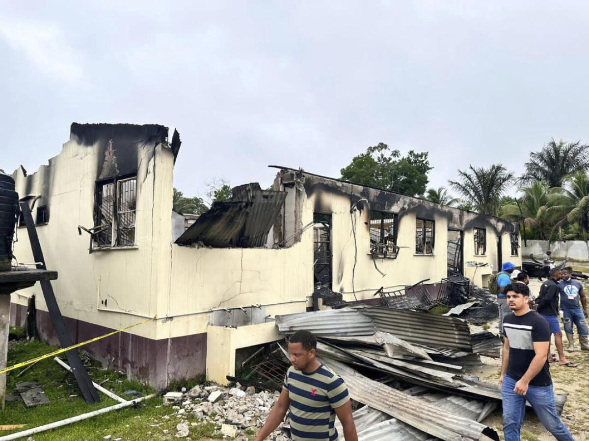In this photo provided by Guyana's Department of Public Information, the dormitory of a secondary school is burned in Mahdia, Guyana, Monday, May 22, 2023. A nighttime fire raced through the dormitory early Monday, killing at least 20 students and injuring several others, authorities said. (Guyana's Department of Public Information via AP Photo)