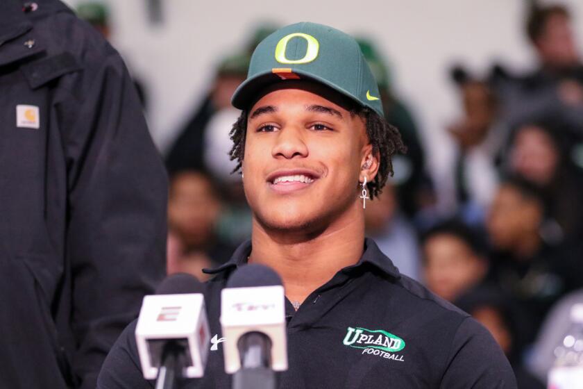 Linebacker Justin Flowe smiles while wearing an Oregon hat.