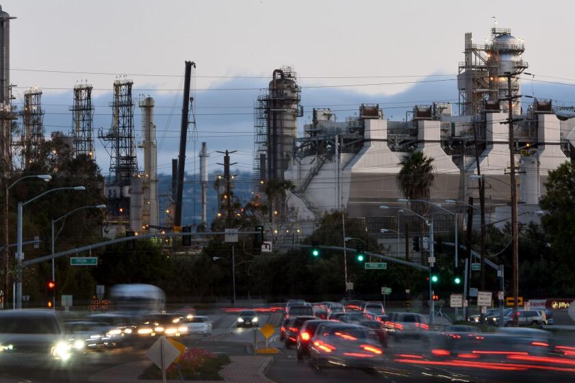 TORRANCE, CA - MAY 9, 2016: Cars drive by the ExxonMobil refinery in Torrance. ExxonMobil planned to fire up a key part of the Torrance refinery that helps process gasoline on Monday night. As part of its start-up procedure, Exxon Mobil plans to turn off the refinery's pollution control system for six hours during a 12-hour period, a step approved by the South Coast Air Quality Management District as a safety precaution. (Michael Owen Baker / For The Times)