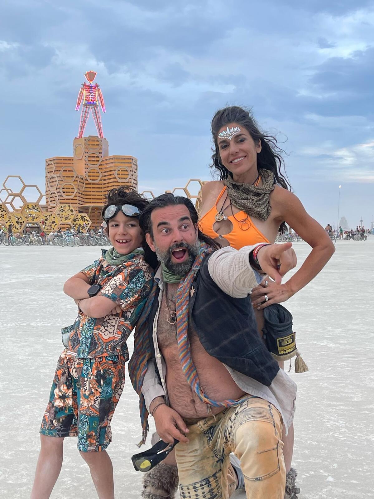 Bianca Snyder poses with her husband and son Tage while at Burning Man.