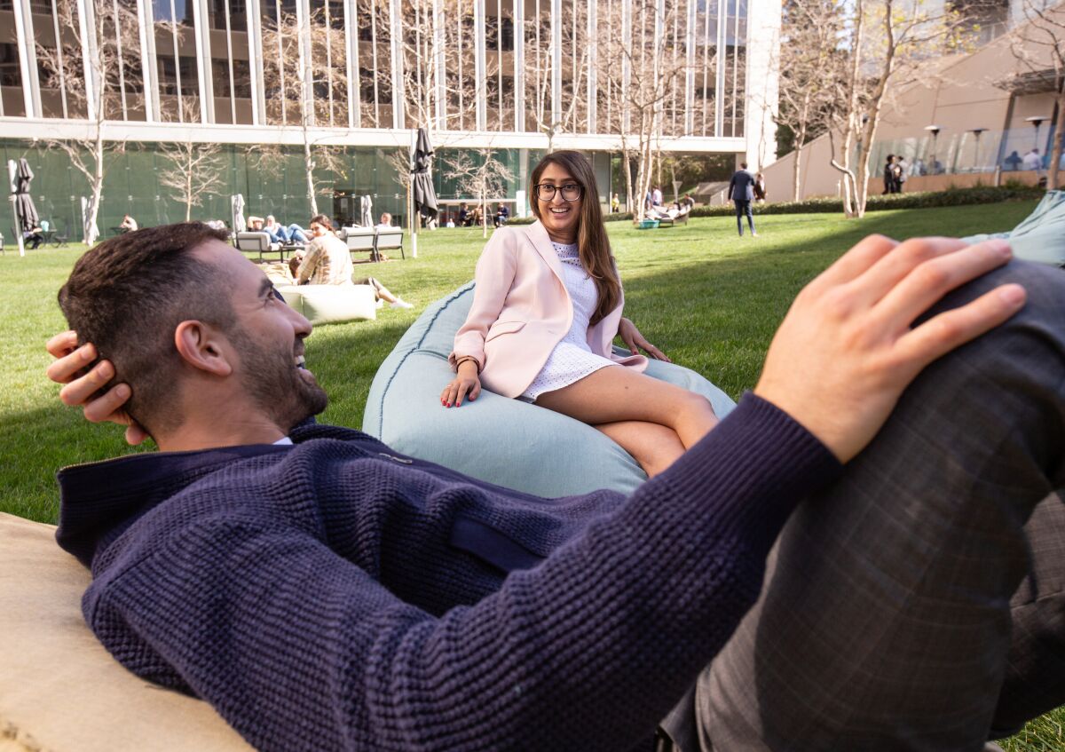 Gabriel Henriquez and Sabrina Hashmi both of Los Angeles enjoy some time in the courtyard of the Century Plaza Towers in Century City.