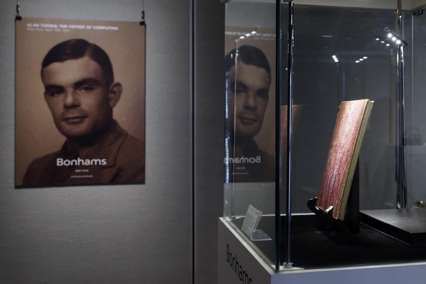 FILE - In this Thursday, March 19, 2015 file photo, a notebook of British mathematician Alan Turing is displayed in front of his portrait during an auction preview in Hong Kong. Thousands of men convicted under now-abolished anti-homosexuality laws in Britain have been pardoned posthumously under a law passed on Tuesday, Jan. 31, 2017 and many more still alive can now apply to have their criminal convictions wiped out. Calls for a general pardon have noted the 1954 suicide of World War II codebreaking hero Alan Turing after his conviction for "gross indecency." After he received a posthumous royal pardon in 2013, pressure for pardons intensified. (AP Photo/Kin Cheung, file)