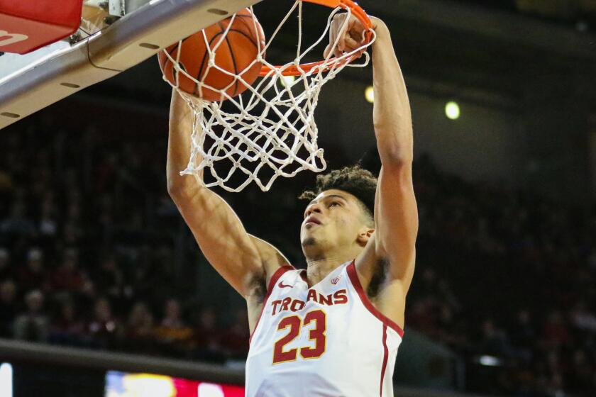 USC freshman guard Max Agbonkpolo throws down a slam dunk in the first half against Long Beach State at the Galen Center on Dec. 15, 2019.