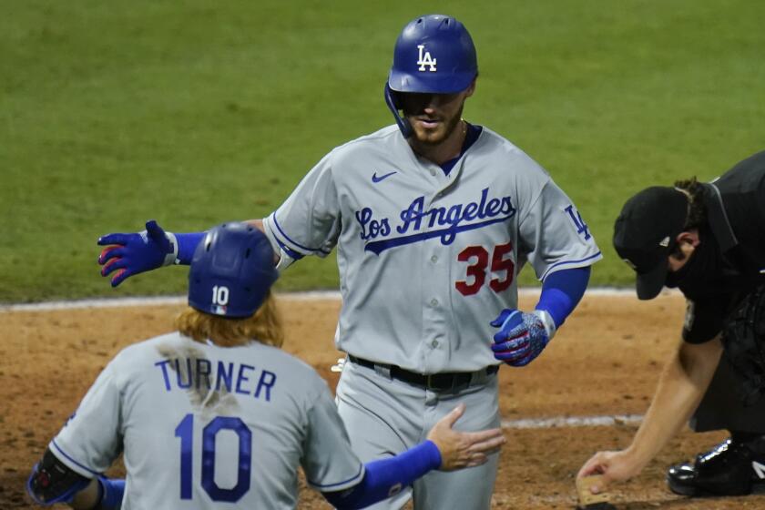 Los Angeles Dodgers' Cody Bellinger (35) celebrates his two-run home run with Justin Turner during the sixth inning.