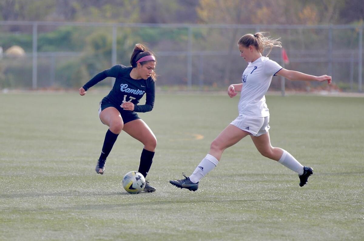 El Camino Real striker Nikki Velasco, left,  maneuvers the ball around Palisades defender Alex Digennaro.