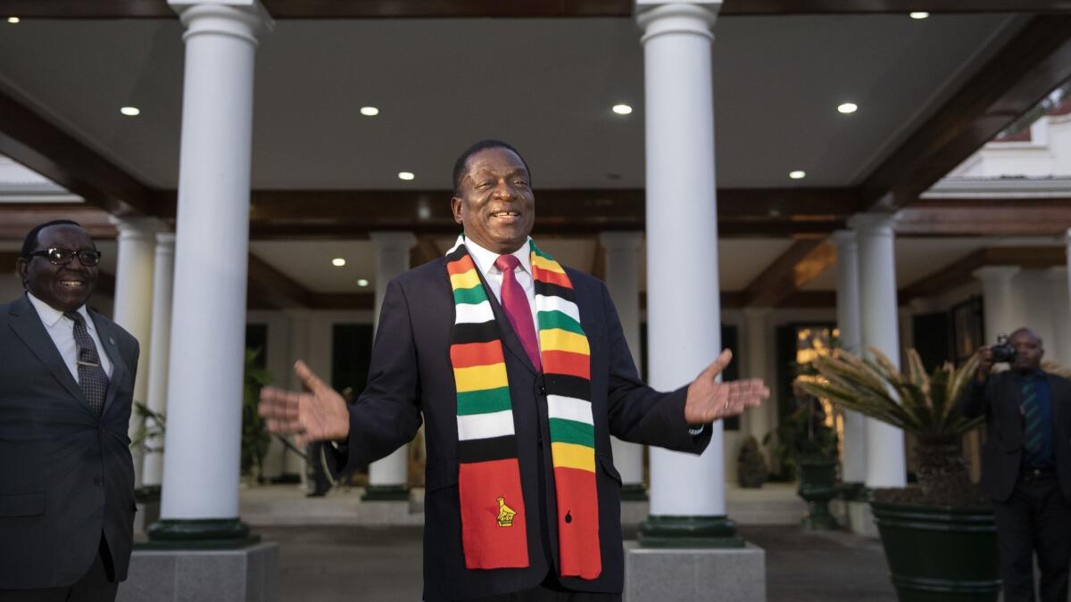 President Emmerson Mnangagwa steps onto the lawn to pose for photographs after a news conference Friday.
