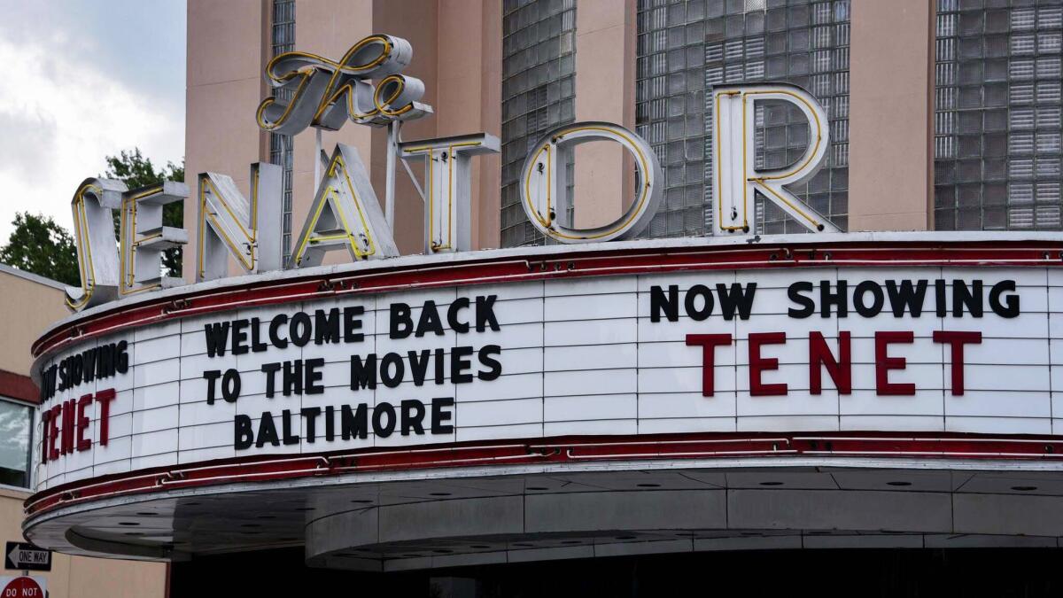 A marquee outside the Senator theater reads "Welcome back to the movies Baltimore" and "Now showing Tenet"