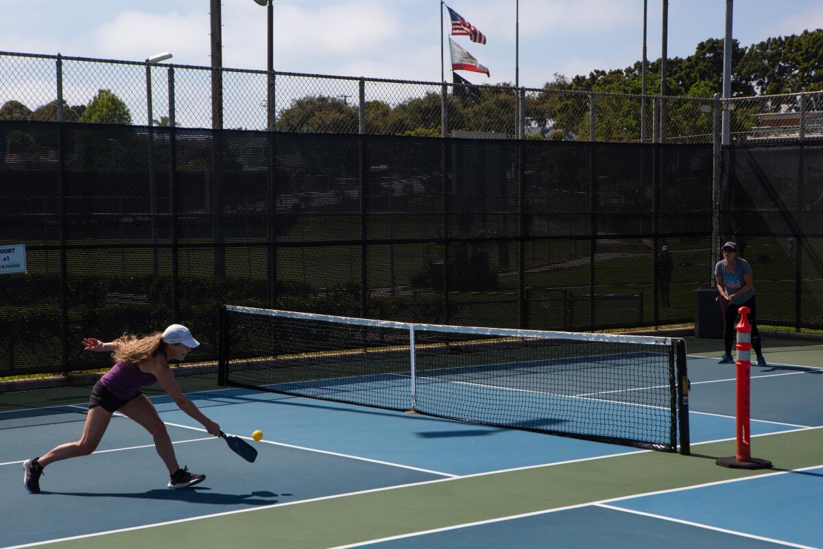 Two women play pickleball at a park in El Segundo