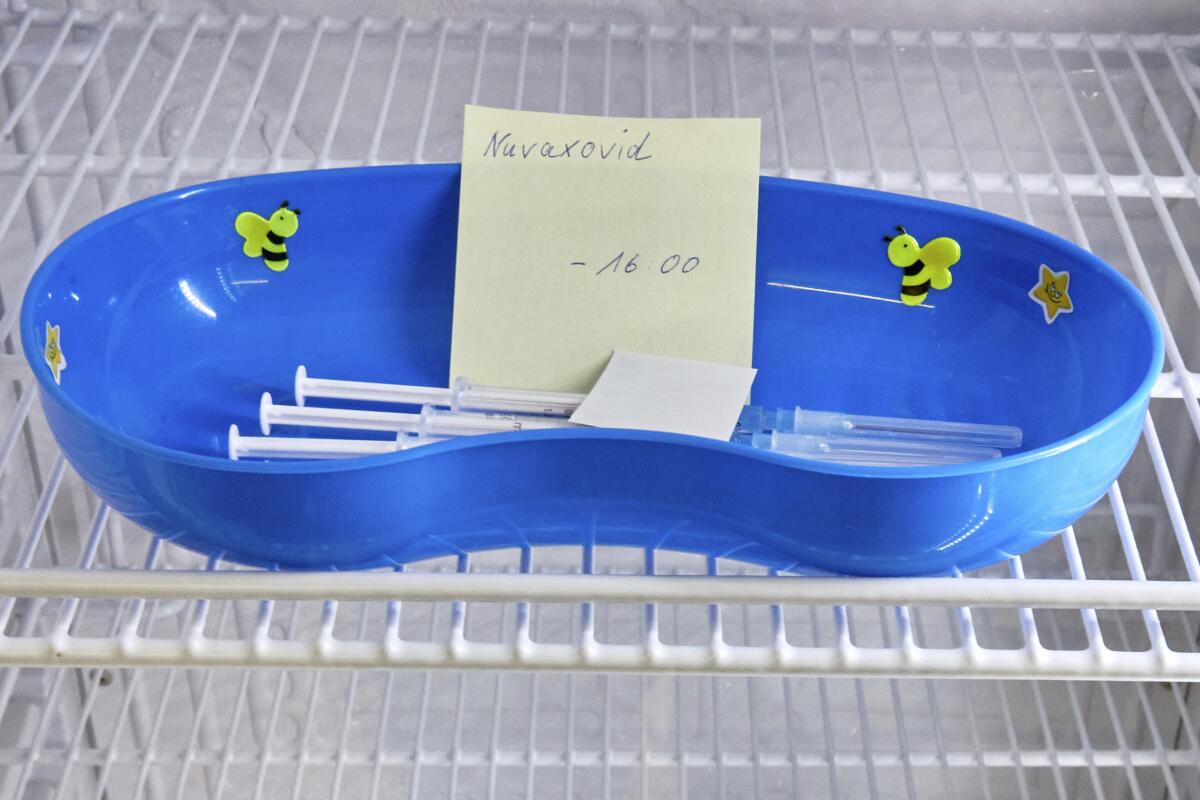 A dish with syringes containing the Novavax COVID-19 vaccine sits in a refrigerator 