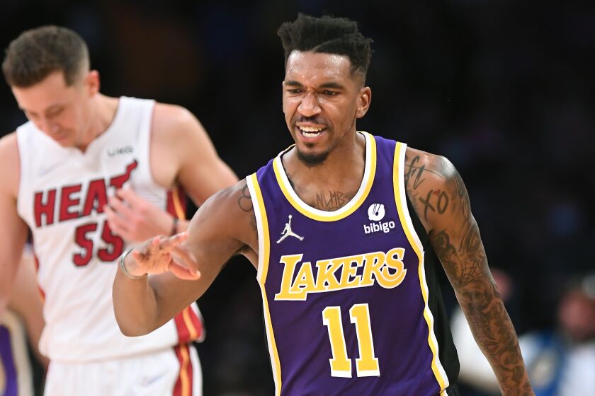 Lakers Malik Monk celebrates his three-pointer against the Heat in the fourth quarter at the Staples Center Wednesday.