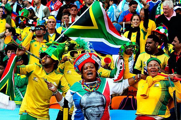 Fans show their support for soccer and former South Africa president Nelson Mandela at the Opening Ceremony at Soccer City Stadium.