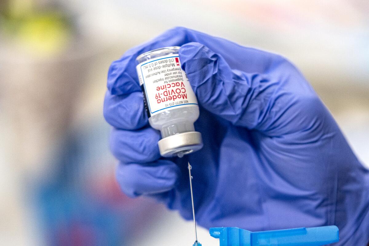 A nurse fills up a syringe with the Moderna Covid-19 vaccine.