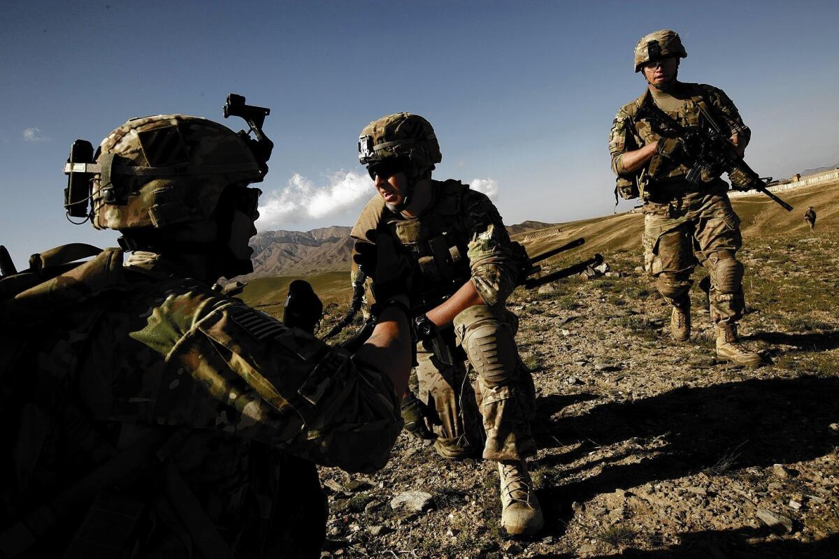 Sgt. Christopher Lee of Beverly Hills, left, and Pvt. Tyler Hartzheim of Palos Verdes, center, and other U.S. soldiers take part in an operation in support of Afghan troops in Wardak province.