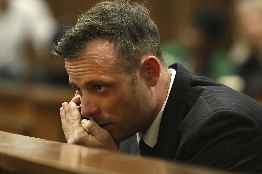Oscar Pistorius speaks on a mobile phone during his sentencing hearing in Pretoria, South Africa, June 15, 2016