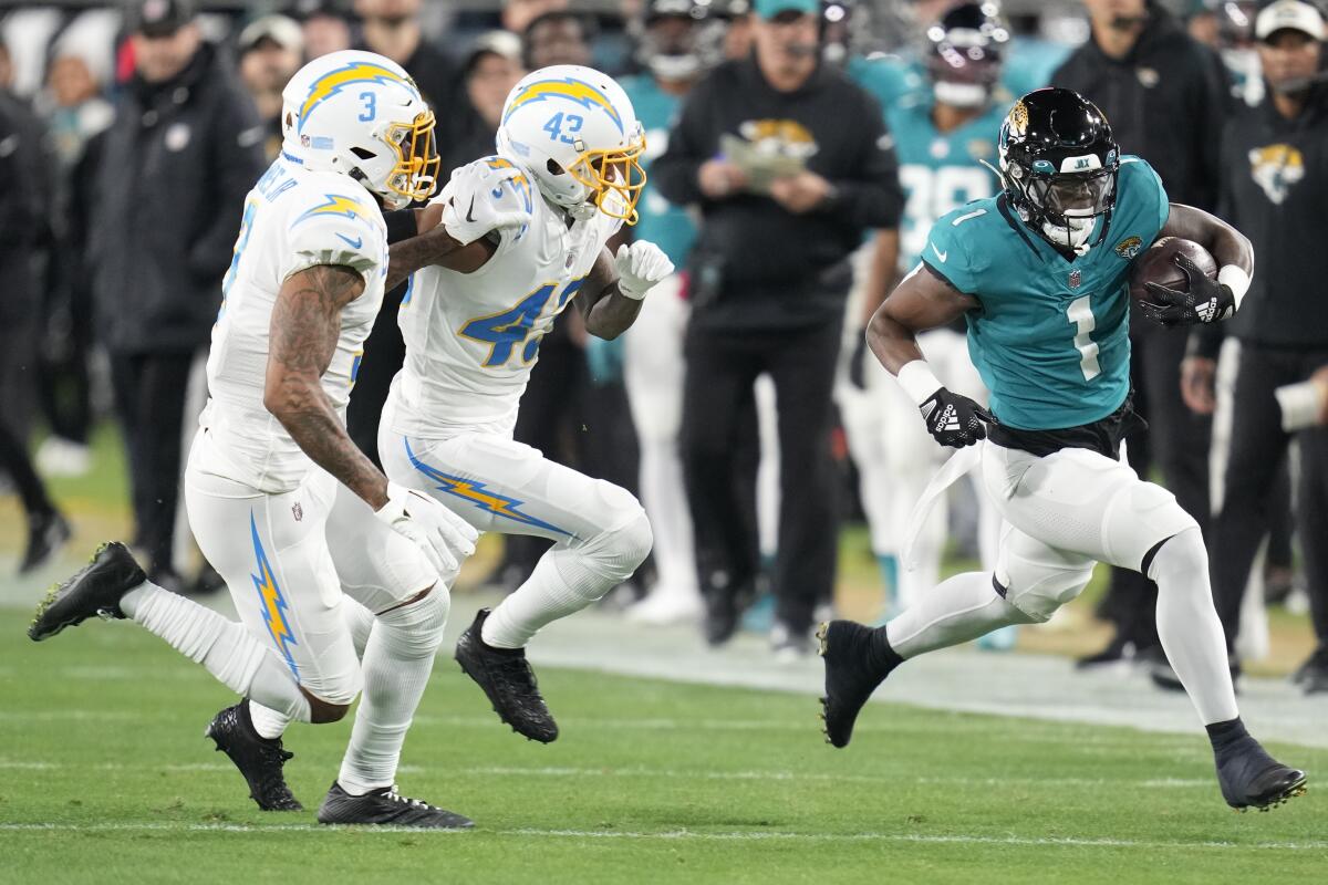 Jacksonville Jaguars running back Travis Etienne Jr. carries the ball against the Chargers on Saturday.